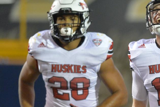 Northern Illinois quarterback Ryan Graham (17) and running back Joel Bouagnon (28) celebrate after Bouagnon's 2-yard rushing touchdown during the fourth quarter of an NCAA college football game against Toledo on Tuesday, Nov. 3, 2015, in Toledo, Ohio. Northern Illinois won 32-27. (AP Photo/David Richard)