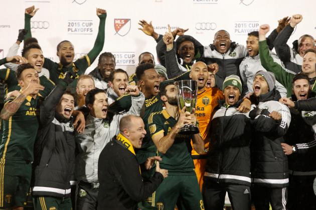 Portland Timbers midfielder Diego Valeri, middle, kisses the trophy after winning the MLS soccer western conference championship, Sunday, Nov. 29, 2015, in Frisco, Texas. The teams tie 2-2, but Portland advanced to the MLS championship on aggregate score. (AP Photo/Brad Loper)