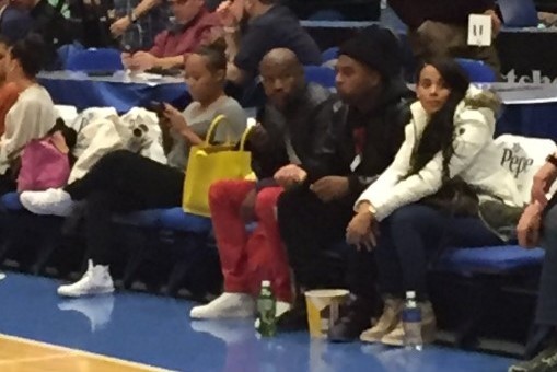 Floyd Mayweather looks downcast while sitting courtside at Los