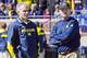 Michigan defensive coordinator D.J. Durkin, left, and head coach Jim Harbaugh, right, watch players warmup before the NCAA college football team's spring game in Ann Arbor, Mich., Saturday, April 4, 2015. (AP Photo/Tony Ding)