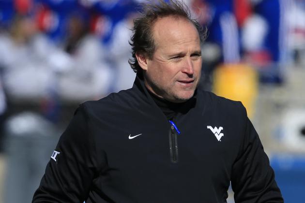 West Virginia head coach Dana Holgorsen walks the sidelines during the first half of an NCAA college football game against Kansas in Lawrence, Kan., Saturday, Nov. 21, 2015. (AP Photo/Orlin Wagner)