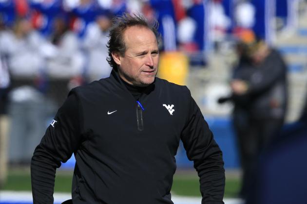 West Virginia head coach Dana Holgorsen walks the sidelines during the first half of an NCAA college football game against Kansas in Lawrence, Kan., Saturday, Nov. 21, 2015. (AP Photo/Orlin Wagner)