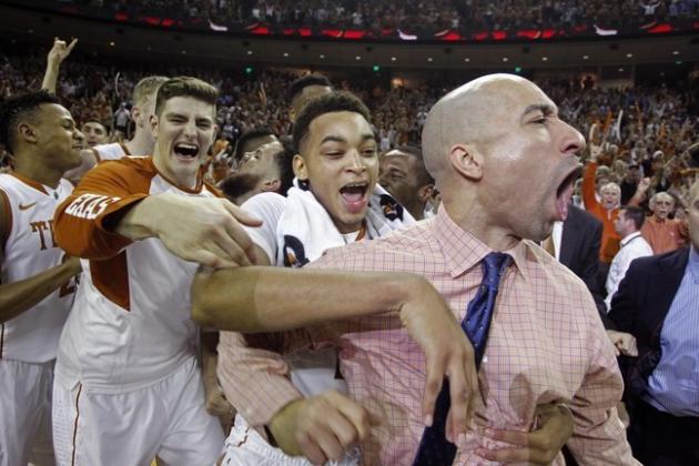 Texas head coach Shaka Smart, right, celebrates his team's last second shot to beat North Carolina during the second half of an NCAA college basketball game, Saturday, Dec. 12, 2015, in Austin, Texas. Texas won 84-82. (AP Photo/Michael Thomas)