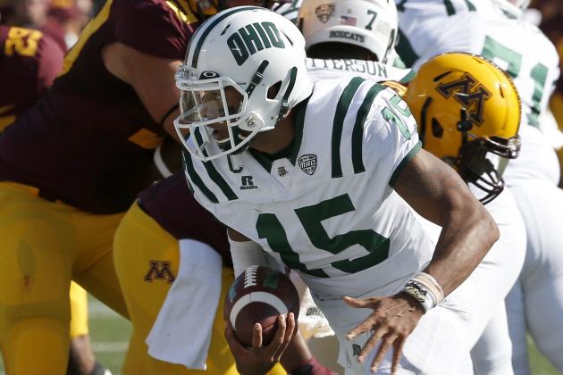 Ohio quarterback Derrius Vick (15) carries the ball for a short gain during the first half of an NCAA college football game against Minnesota in Minneapolis Saturday, Sept. 26, 2015. (AP Photo/Ann Heisenfelt)