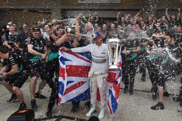 Mercedes AMG Petronas driver Lewis Hamilton of Britain celebrates with team members in the pit lane after winning the United States Formula One Grand Prix and the Drivers Championships at the Circuit of The Americas in Austin, Texas on October 25, 2015. AFP PHOTO / MARK RALSTON (Photo credit should read MARK RALSTON/AFP/Getty Images)