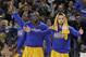 Golden State Warriors guard Stephen Curry, right, celebrates on the bench with forward Draymond Green, center, and forward Harrison Barnes during the second half of an NBA basketball game against the Los Angeles Lakers in Oakland, Calif., Tuesday, Nov. 24, 2015. The Warriors won 111-77. (AP Photo/Jeff Chiu)