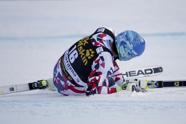 Germany's Matthias Mayer lies on the snow after crashing during an alpine ski, men's World Cup downhill, in Val Gardena, Italy, Saturday, Dec. 19, 2015. (AP Photo/Armando Trovati)