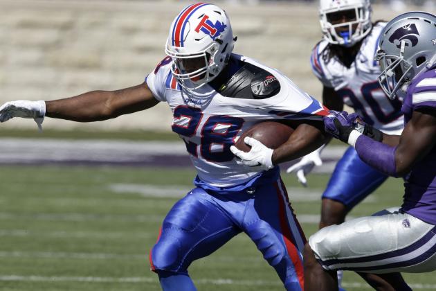 Louisiana Tech running back Kenneth Dixon (28) is tackled by Kansas State defensive back Johnathan Durham (6) during the first half of an NCAA college football game in Manhattan, Kan., Saturday, Sept. 19, 2015. (AP Photo/Orlin Wagner)