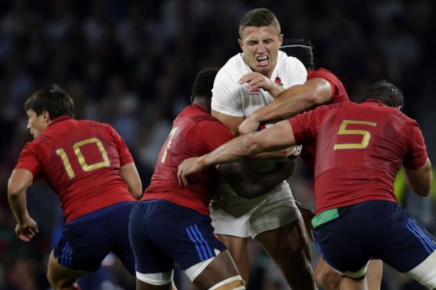 England’s Sam Burgess, centre is tackled by France’s Flugence Ouedraogo, left and France’s Yoann Maestri right, during an international friendly rugby match between England and France at Twickenham stadium in London, Saturday, Aug. 15, 2015. A series of friendly internationals are being held in advance of the upcoming Rugby World Cup that starts in September. (AP Photo/Alastair Grant)