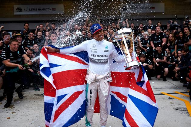 AUSTIN, TX - OCTOBER 25:  Lewis Hamilton of Great Britain and Mercedes GP celebrates with the team in the pit lane after winning the United States Formula One Grand Prix and the championship at Circuit of The Americas on October 25, 2015 in Austin, United States.  (Photo by Steve Etherington/Getty Images)