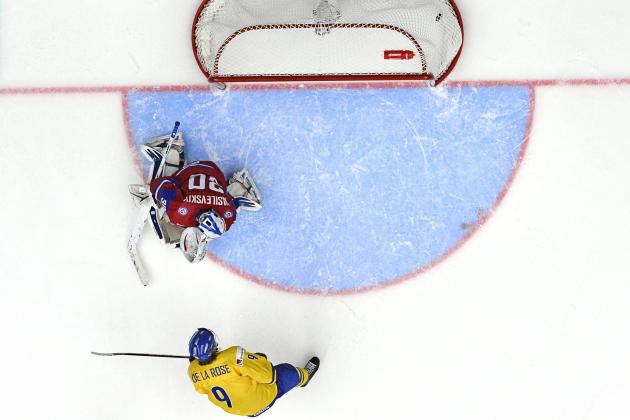 Sweden's Jacob de la Rose, bottom,  scores the winning goal past Russia's goal keeper Andrei Vasilevski in the IIHF World Junior Championship preliminary round group B ice hockey match between Sweden and Russia at Malmo Arena in Malmo, Sweden, on Tuesday  Dec. 31, 2013. (AP Photo/TT/Ludvig Thunman)   SWEDEN OUT