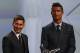 FC Barcelone Argentinian striker Lionel Messi (2ndR) shares a laugh with his Urugayan teammate Luis Suarez (2ndL) and Danish former football player and ceremony host Peter Schmeichel (L) eyed by Real Madrid's Portuguese striker Cristiano Ronaldo during the awarding ceremony for the Best Men's player in Europe at the end of the UEFA Champions League Group stage draw ceremony, on August 27, 2015 in Monaco. AFP PHOTO / VALERY HACHE (Photo credit should read VALERY HACHE/AFP/Getty Images)