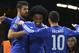 Chelsea's Brazilian midfielder Willian (C) celebrates with Chelsea's Brazilian-born Spanish striker Diego Costa (L) and Chelsea's Belgian midfielder Eden Hazard (R) after Willian scored their second goal during the UEFA Champions League Group G football match between Chelsea and Porto at Stamford Bridge in London on December 9, 2015. AFP PHOTO / GLYN KIRK / AFP / GLYN KIRK (Photo credit should read GLYN KIRK/AFP/Getty Images)