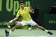 TOPSHOT - Novak Djokovic of Serbia returns the ball to Germany's Dustin Brown during their tennis match in the Qatar Open competition on January 4, 2016, in Doha. AFP PHOTO / KARIM JAAFAR / AFP / KARIM JAAFAR (Photo credit should read KARIM JAAFAR/AFP/Getty Images)