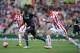 Liverpool's Zaire-born Belgian striker Christian Benteke (2nd L) runs with the ball during the English Premier League football match between Stoke City and Liverpool at the Britannia Stadium in Stoke-on-Trent, central England on August 9, 2015. AFP PHOTO / OLI SCARFF RESTRICTED TO EDITORIAL USE. No use with unauthorized audio, video, data, fixture lists, club/league logos or 'live' services. Online in-match use limited to 75 images, no video emulation. No use in betting, games or single club/league/player publications.. (Photo credit should read OLI SCARFF/AFP/Getty Images)