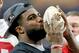 Ohio State running back Ezekiel Elliott kisses the trophy after their 44-28 win over Notre Dame in the Fiesta Bowl NCAA college football game. Friday, Jan. 1, 2016, in Glendale, Ariz. (AP Photo/Rick Scuteri)