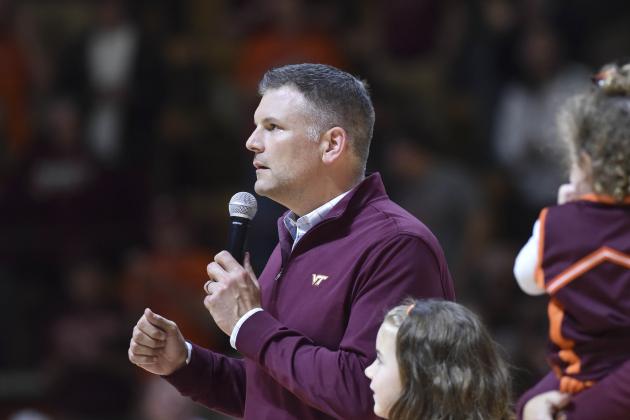 Dec 1, 2015; Blacksburg, VA, USA; The new Virginia Tech Hokies head football coach Justin Fuente (L) speaks to the fans during halftime against the Northwestern Wildcats at Cassell Coliseum. The Wildcats won 81-79. Mandatory Credit: Michael Shroyer-USA TODAY Sports