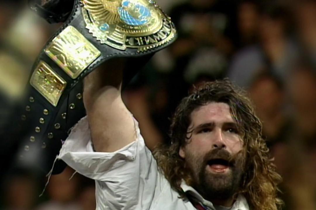 Foley holds the WWF World Heavyweight title in the air after winning it for the 1st time.