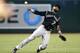 Colorado Rockies' Jose Reyes makes an off balance throw to first base to try in vain to get Arizona Diamondbacks' Jamie Romak during the eighth inning of a baseball game Wednesday, Sept. 30, 2015, in Phoenix. The Rockies' Reyes would get a throwing error on the play allowing Diamondbacks' Romak to reach second base. (AP Photo/Ross D. Franklin)