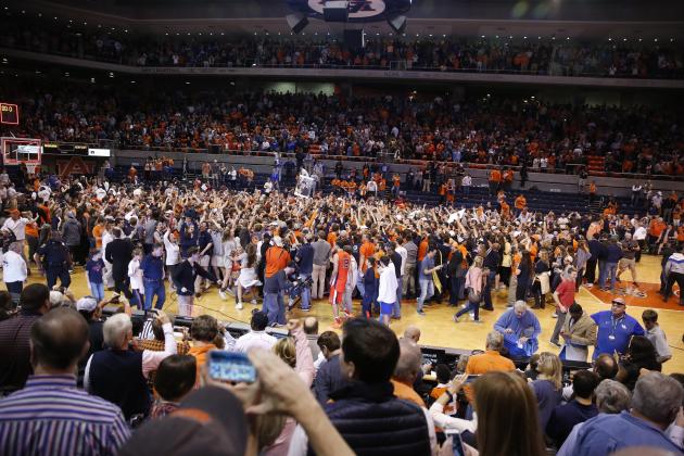 Auburn fans swarm the court after beating Kentucky 75-70 after an NCAA college basketball game, Saturday, Jan. 16, 2016, in Auburn, Ala. (AP Photo/Brynn Anderson)