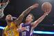 Sacramento Kings guard Nik Stauskas, right, shoots as Los Angeles Lakers center Robert Sacre defends during the second half of an NBA basketball game, Wednesday, April 15, 2015, in Los Angeles. The Kings won 122-99. (AP Photo/Mark J. Terrill)