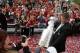 Mike Bolt carries the Stanley Cup on the red carpet before an NHL hockey game between the New York Rangers and the Chicago Blackhawks Wednesday, Oct. 7, 2015, in Chicago. (AP Photo/Nam Y. Huh)