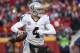 Oakland Raiders quarterback Derek Carr (4) looks to throw against the Kansas City Chiefs during the first half of their NFL football game in Kansas City, Mo., Sunday, Jan, 3, 2016. (AP Photo/Reed Hoffmann)
