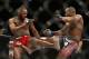 Daniel Cormier, right, kicks Jon Jones during their light heavyweight title mixed martial arts bout at UFC 182, Saturday, Jan. 3, 2015, in Las Vegas. (AP Photo/John Locher)