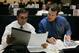 Denver Broncos head coach Mike Shanahan, left, and general manager Ted Sundquist compare notes in the draft room at the Broncos headquarters during the opening round of the NFL draft in Denver on Saturday, April 29, 2006. The Broncos were scheduled to make the 15th pick in the first round. (AP Photo/Ed Andrieski)