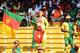 A fan painted in the colours of the Cameroon flag holds up the national flag during the 2015 African Cup of Nations (CAF) qualifier, group D, football match Cameroon vs DR Congo at the Ahmadou Ahidjo stadium in Yaounde on November 15, 2014. Cameroon 1-0. AFP PHOTO/PACOME PABANDJI (Photo credit should read PACOME PABANDJI/AFP/Getty Images)