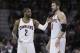 Cleveland Cavaliers' Kyrie Irving, left, talks with Kevin Love during an NBA basketball game against the Miami Heat Wednesday, Feb. 11, 2015, in Cleveland. (AP Photo/Tony Dejak)