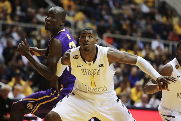 West Virginia forward Jonathan Holton (1) blocks out LSU forward John Odo (31) during an NCAA college basketball game, Thursday, Dec. 4, 2014, in Morgantown, W.Va. (AP Photo/Raymond Thompson)