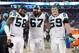 CHARLOTTE, NC - JANUARY 24: Thomas Davis #58, Ryan Kalil #67 and Luke Kuechly #59 of the Carolina Panthers pose on the sidelines during the NFC Championship Game against the Arizona Cardinals at Bank of America Stadium on January 24, 2016 in Charlotte, North Carolina. (Photo by Streeter Lecka/Getty Images)