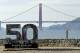 A Super Bowl 50 sign rests on the beach near the Golden Gate Bridge Friday, Feb. 5, 2016, in San Francisco. (AP Photo/Charlie Riedel)