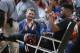 Chicago Bulls guard Jimmy Butler waves to fans as they applaud him while Butler is taken off the court after being injured late in the first half of his team's NBA basketball game against the Denver Nuggets on Friday, Feb. 5, 2016, in Denver. (AP Photo/David Zalubowski)