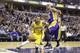 Indiana Pacers guard George Hill (3) cuts under Los Angeles Lakers center Robert Sacre (50) during the second half of an NBA basketball game in Indianapolis, Monday, Feb. 8, 2016. The Pacers defeated the Lakers 89-87. (AP Photo/Michael Conroy)