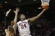 Oklahoma guard Buddy Hield (24) shoots behind Texas forward Connor Lammert, left, in the second half of an NCAA college basketball game in Norman, Okla., Monday, Feb. 8, 2016. Oklahoma won 63-60. (AP Photo/Sue Ogrocki)