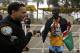 Men's' third-place finisher Daniel Limo celebrates with a Santa Monica police officer after the Los Angeles Marathon, Sunday, Feb. 14, 2016, in Santa Monica, Calif. (AP Photo/Chris Carlson)