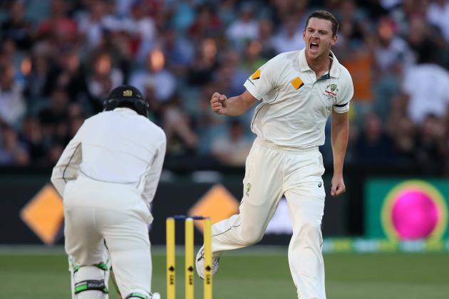 Australia's Josh Hazlewood, right, celebrates the wicket of New Zealand's Martin Guptill, left, during their cricket test in Adelaide, Saturday, Nov. 28, 2015. This match is the sport's first ever day-night test. (AP Photo/Rick Rycroft)
