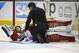 Calgary Flames goalie Karri Ramo is checked on by a trainer after Ramo's collision with San Jose Sharks' Joonas Donskoi during the third period of an NHL hockey game in San Jose, Calif., Thursday, Feb. 11, 2016. The Flames defeated the Sharks 6-5 in a shootout. (AP Photo/Tony Avelar)