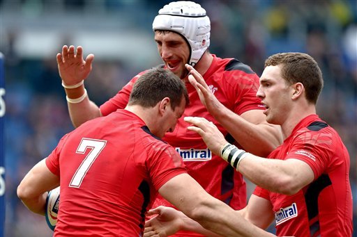 Wales' Sam Warburton, left, celebrates with his teammates after scoring a try during the Six Nations Rugby match between Italy and Wales at the Rome Olympic Stadium Saturday, March 21, 2015. Wales unleashed a stunning seven-try second half to crush Italy 61-20 at Stadio Olimpico. (AP Photo/Ettore Ferrari, Ansa)