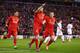 LIVERPOOL, ENGLAND - FEBRUARY 25: James Milner (C) of Liverpool celebrates scoring his team's first goal with his team mates Roberto Firmino (L) and Philippe Coutinho (R) during the UEFA Europa League Round of 32 second leg match between Liverpool and FC Augsburg at Anfield on February 25, 2016 in Liverpool, United Kingdom. (Photo by Clive Brunskill/Getty Images)