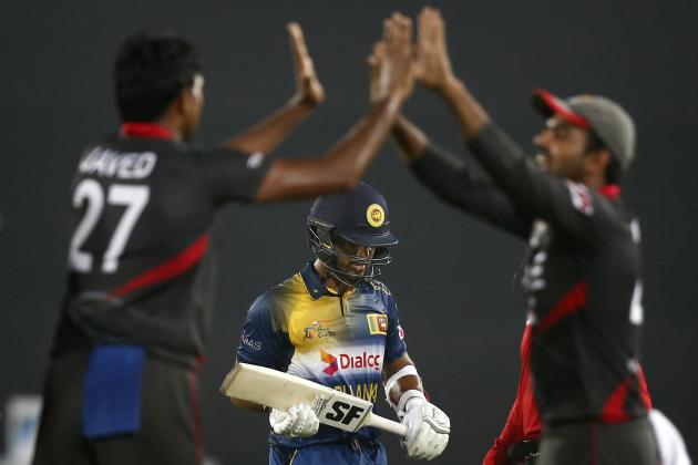 United Arab Emirates’ captain, Amjad Javed, left, celebrates with teammate Shaiman Anwar, right, after the dismissal of Sri Lanka’s Dinesh Chandimal, center, during their Asia Cup Twenty20 international cricket match in Dhaka, Bangladesh, Thursday, Feb. 25, 2016. (AP Photo/A.M. Ahad)