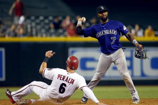 Arizona Diamondbacks left fielder David Peralta (6) is forced out at second as Colorado Rockies shortstop Jose Reyes (7) throws out Welington Castillo during the sixth inning of a baseball game, Tuesday, Sept. 29, 2015, in Phoenix. (AP Photo/Matt York)
