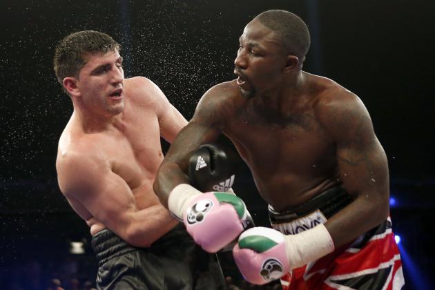 Britain's Ola Afolabi, right, lands a punch to Germany's Marco Huck during their WBO cruiserweight championship title bout in Berlin, Germany, Saturday, June 8, 2013. Huck retained his WBO belt by defeating Afolabi by majority decision on Saturday. (AP Photo/Michael Sohn)