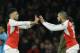 Alex Oxlade-Chamberlain (left) being substituted for Theo Walcott.