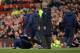 Manchester United's Dutch manager Louis van Gaal (L) falls over on the touchline in front of fourth official Mike Dean (3R) and Arsenal's French manager Arsene Wenger (2R) during the English Premier League football match between Manchester United and Arsenal at Old Trafford in Manchester in north west England on February 28, 2016. / AFP / OLI SCARFF / RESTRICTED TO EDITORIAL USE. No use with unauthorized audio, video, data, fixture lists, club/league logos or 'live' services. Online in-match use limited to 75 images, no video emulation. No use in betting, games or single club/league/player publications. / (Photo credit should read OLI SCARFF/AFP/Getty Images)