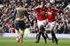 Manchester United's Marcus Rashford, left celebrates with teammate Juan Mata after he sores the opening goal of the game during the English Premier League soccer match between Manchester United and Arsenal at Old Trafford Stadium, Manchester, England, Sunday, Feb. 28, 2016. (AP Photo/Jon Super)