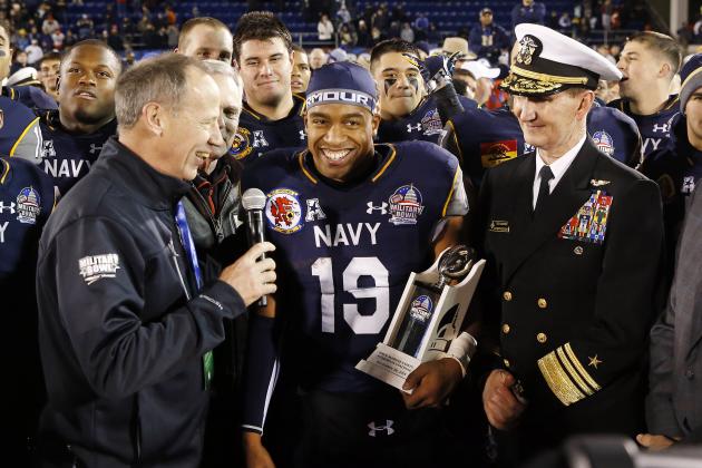 Navy quarterback Keenan Reynolds (19) holds a trophy after being named Most Valuable Player after the Military Bowl NCAA college football game against Pittsburgh, Monday, Dec. 28, 2015, in Annapolis, Md. Navy won 44-28. (AP Photo/Patrick Semansky)