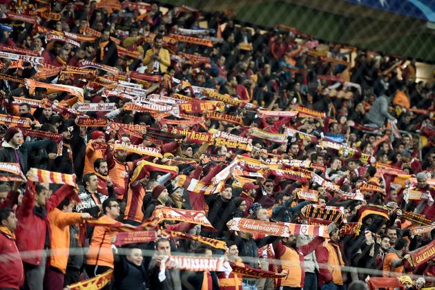 Galatasaray's supporters hold scarves during the UEFA Champions League Group C football match between Galatasaray AS and FC Astana at the Turk Telekom Arena in Istanbul on December 8, 2015. / AFP / OZAN KOSE (Photo credit should read OZAN KOSE/AFP/Getty Images)